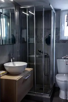 a bathroom with a shower and a sink and a toilet at Meandros apartment city center in Athens