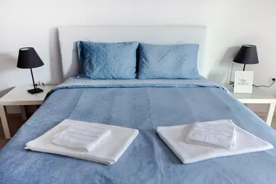 a blue bed with two white plates on it at Meandros apartment city center in Athens