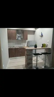 a kitchen with a counter and two bar stools at Piraeus historical center in Piraeus