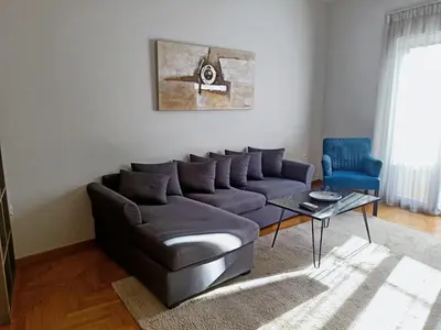 a living room with a couch and a table at Siggrou apartment in Athens