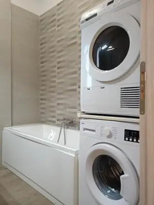 a washing machine and a dryer in a bathroom at Siggrou apartment in Athens