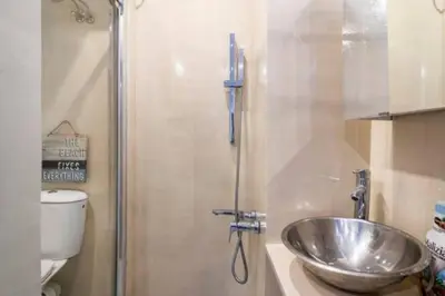 a bathroom with a sink and a shower at Santorini Style at Nathional Archeological museum of Athens,Greece in Athens
