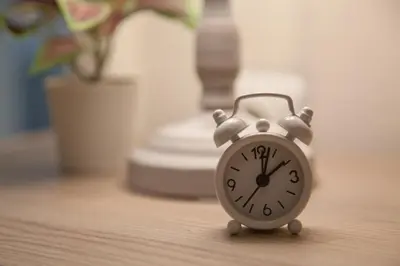 a small alarm clock sitting on a table at Lovely Nest Piraeus in Piraeus