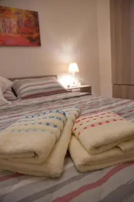 a bedroom with a bed with two pillows on it at Lovely Nest Piraeus in Piraeus