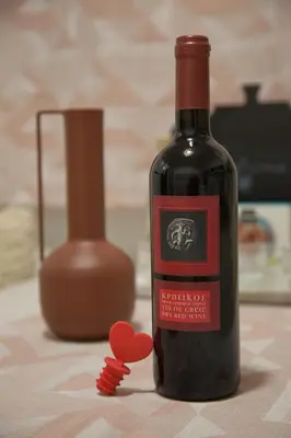 a bottle of wine with a red heart on a table at Lovely Nest Piraeus in Piraeus