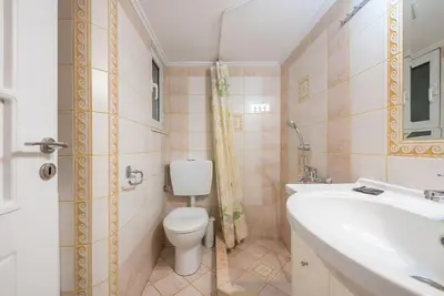 a bathroom with a toilet and a sink at Pegasus Apartment in Piraeus