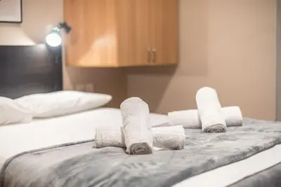 a group of rolled towels on top of a bed at Pegasus Apartment in Piraeus