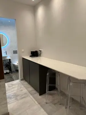 a kitchen with a counter and stools in a room at Palace Apartment in Athens