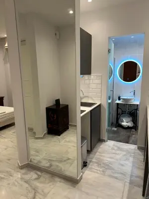a mirror in a room with a sink and a bathroom at Palace Apartment in Athens