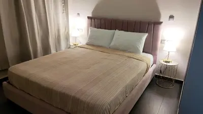 a bedroom with a large bed with two lamps at Ermou Downtown Suites by Athens Urban Retreat in Athens