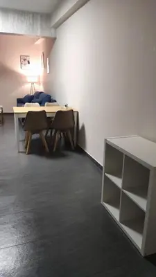a room with a table and chairs and a bed at Ermou Downtown Suites by Athens Urban Retreat in Athens