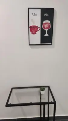 a glass table in front of a wall with a picture at Ermou Downtown Suites by Athens Urban Retreat in Athens