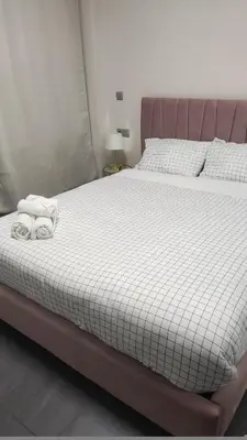 a bed with two towels on top of it at Ermou Downtown Suites by Athens Urban Retreat in Athens