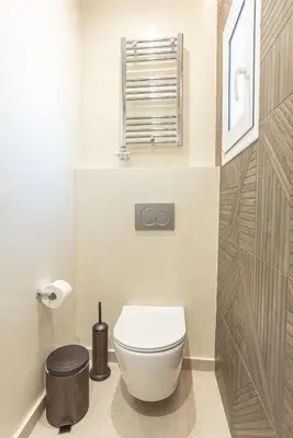 a bathroom with a white toilet and a window at 2bdroom Plaka Apartment in Athens