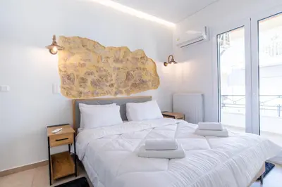 a bedroom with a large white bed with two pillows at 2bdroom Plaka Apartment in Athens
