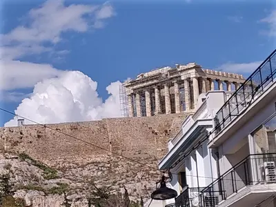 a building on the side of a wall with a street at Studio Next to Acropolis in Athens