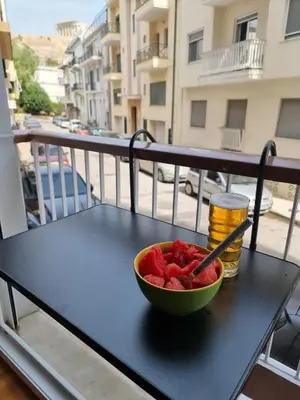 a bowl of fruit sitting on a table on a balcony at Studio Next to Acropolis in Athens