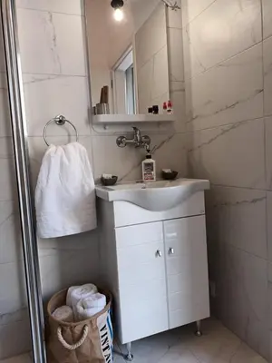 a bathroom with a sink and a mirror at Studio Next to Acropolis in Athens