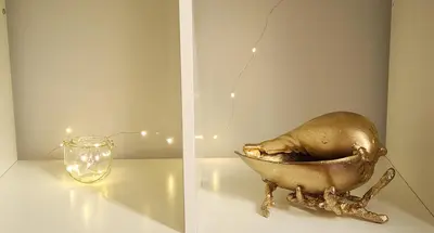 a bird in a bowl next to a glass at Kallithea Gold Apartment greendom in Athens