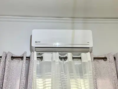 a window unit in a bedroom with curtains at Kallithea Gold Apartment greendom in Athens