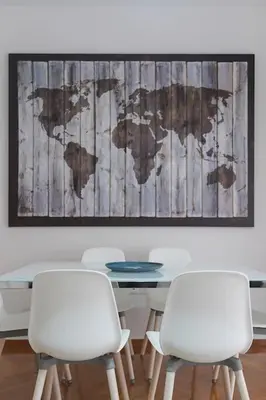 a table with white chairs and a map of the world at The HostMaster Cosmopolitan Downtown Scent in Athens