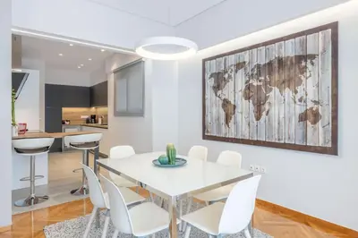 a dining room with a white table and white chairs at The HostMaster Cosmopolitan Downtown Scent in Athens