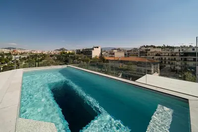 a swimming pool on the roof of a building at The HostMaster Skyline Pool Oasis Penthouse in Athens