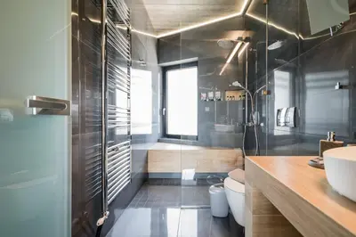 a bathroom with a glass shower and a sink at The HostMaster Skyline Pool Oasis Penthouse in Athens