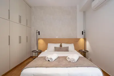 a bedroom with a large white bed with two towels at Deluxe 4 Bedrooms Apartment in Athens Center in Athens