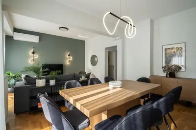 a dining room with a wooden table and chairs at Deluxe 4 Bedrooms Apartment in Athens Center in Athens