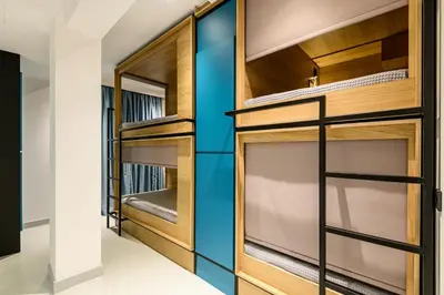 a walk in closet with wood and glass doors at Mosaikon Glostel in Athens