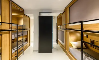 a room with bunk beds and a hallway at Mosaikon Glostel in Athens