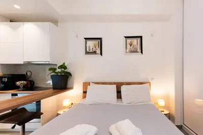 a bedroom with a bed with two towels on it at Modern studio apartment A in Athens