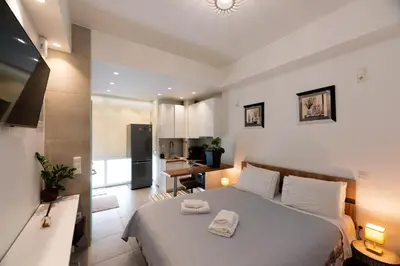 a bedroom with a bed with two towels on it at Modern studio apartment A in Athens