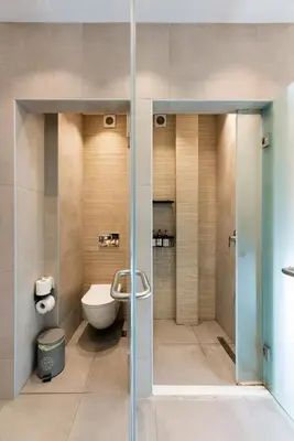 a bathroom with a toilet and a glass shower stall at Modern studio apartment A in Athens