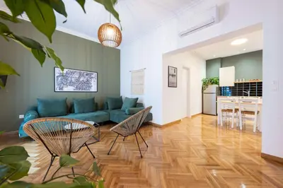 a living room with a couch and a table and chairs at Modita Boutique Apartments in Athens