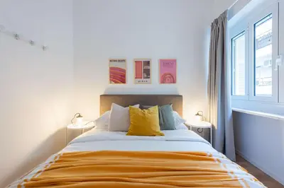 a bedroom with a large bed with yellow pillows at Modita Boutique Apartments in Athens