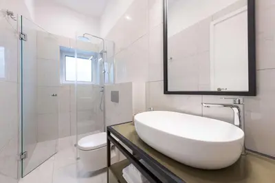 a white bathroom with a sink and a toilet at Modita Boutique Apartments in Athens