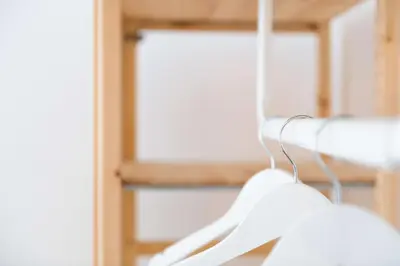a pair of white hangers hanging from a rack at Modita Boutique Apartments in Athens