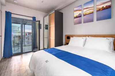 a bedroom with a bed and a large window at Exarchia House Project in Athens
