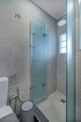 a bathroom with a shower with a glass door at Exarchia House Project in Athens