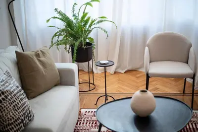 a living room with a couch and a chair and a table at JUST KOLONAKI in Athens