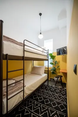 a dorm room with bunk beds and a desk at JUST KOLONAKI in Athens