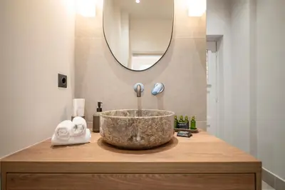 a bathroom with a bowl sink and a mirror at JUST KOLONAKI in Athens