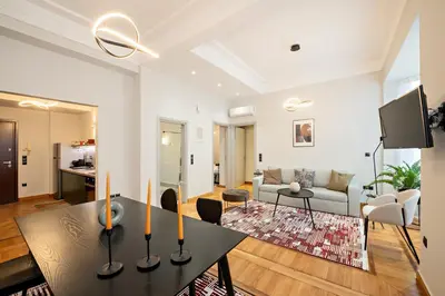 a living room with a table and a couch at JUST KOLONAKI in Athens