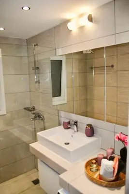 a bathroom with a sink and a shower at GPK Lux 2BR - 7 min walking to Acropolis in Athens
