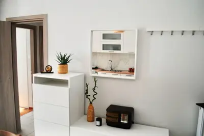 a white kitchen with a microwave on a wall at GPK Lux 2BR - 7 min walking to Acropolis in Athens
