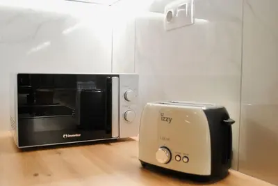 a toaster oven sitting next to a microwave at GPK Lux 2BR - 7 min walking to Acropolis in Athens