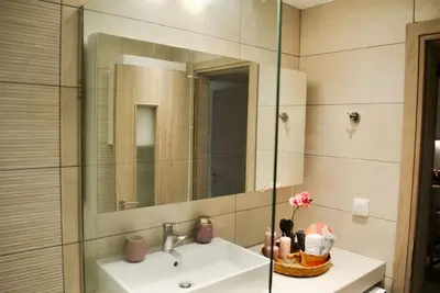 a bathroom with a sink and a mirror at GPK Lux 2BR - 7 min walking to Acropolis in Athens