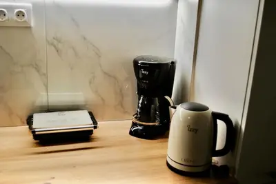 a coffee maker and a coffee mug sitting on a table at GPK Lux 2BR - 7 min walking to Acropolis in Athens